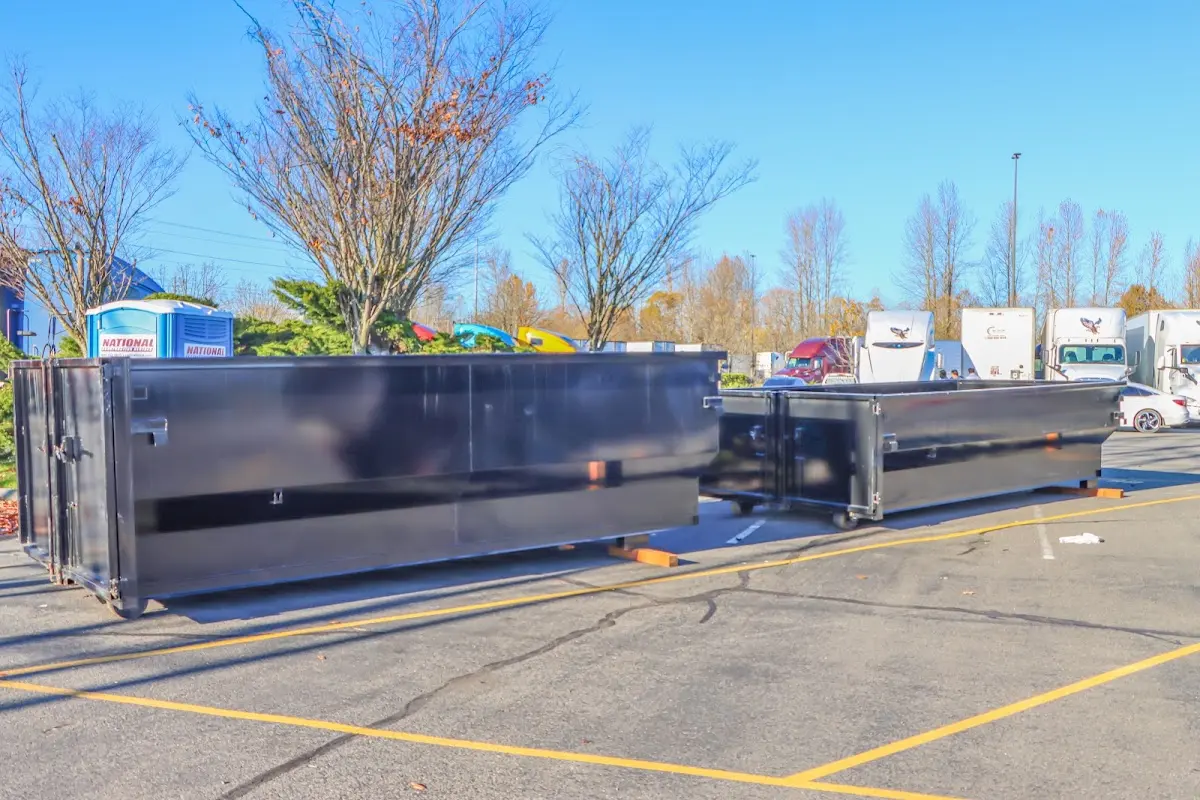 Professional dumpster rental service with roll-off container on residential driveway in Alamo